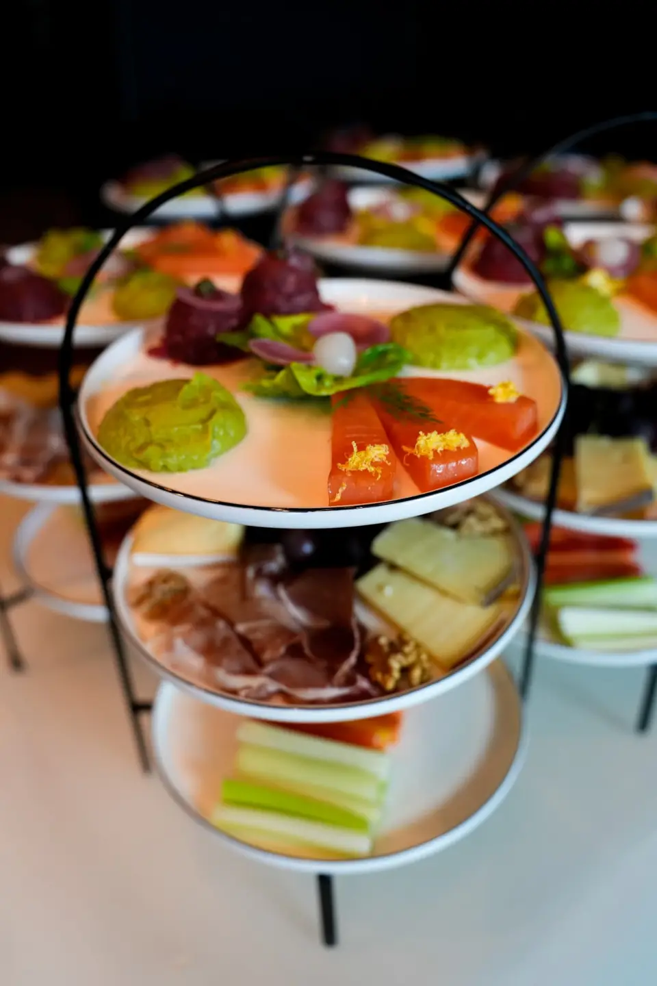 Etagere mit Lachs, Rohschinken, Käse und Gemüse am Apéro-Buffet